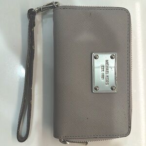 Michael Kors grey wristlet. Card slots. Pocket and divided sections.